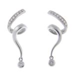 A pair of diamond spiral earrings.