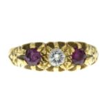An 18ct gold diamond and ruby three-stone ring.Estimated diamond weight 0.15ct,