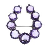 A late 19th century silver amethyst and split pearl horseshoe brooch.May be worn as a