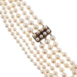 A cultured pearl three-row necklace, with garnet and cultured pearl clasp.