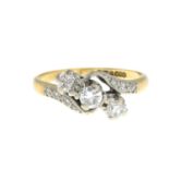 An 18ct gold brilliant-cut diamond three-stone ring, with diamond shoulders.