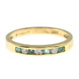 An 18ct gold diamond and emerald seven-stone ring.Estimated total diamond weight 0.15ct.