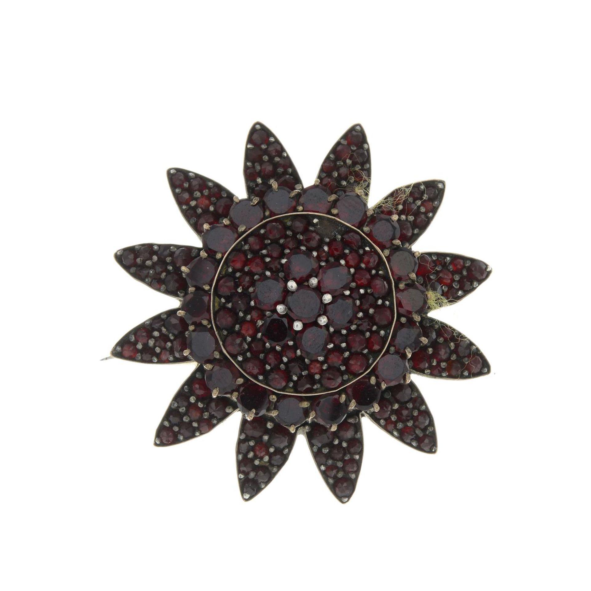 A late 19th century garnet and red paste floral brooch.Diameter 3.6cms.