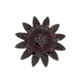 A late 19th century garnet and red paste floral brooch.Diameter 3.6cms.