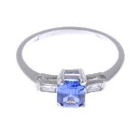 A tanzanite and baguette-cut diamond three-stone ring.Tanzanite calculated weight 0.72ct,