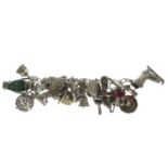 Charm bracelet, stamped silver, length 18cms, 102.9gms.