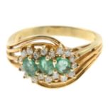 An emerald and diamond dress ring.Estimated total diamond weight 0.15ct.Stamped 14k.Ring size M.