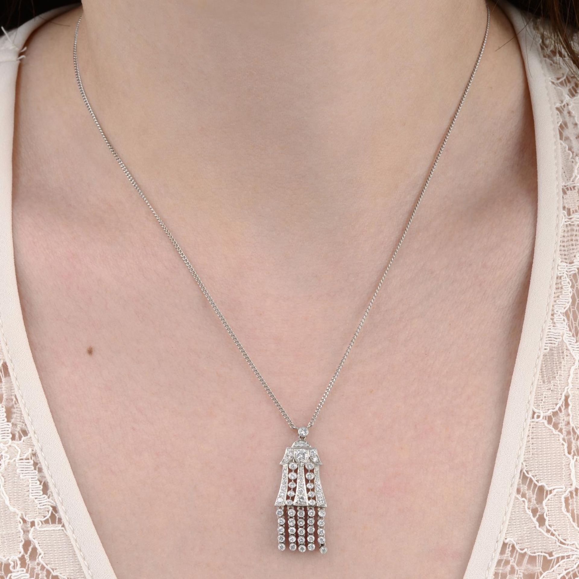 A brilliant-cut diamond tassel pendant,