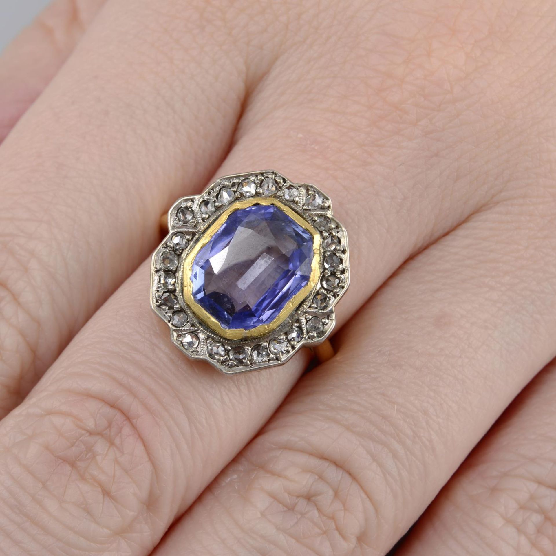 An early 20th century 18ct gold sapphire and rose-cut diamond cluster ring.Calculated sapphire