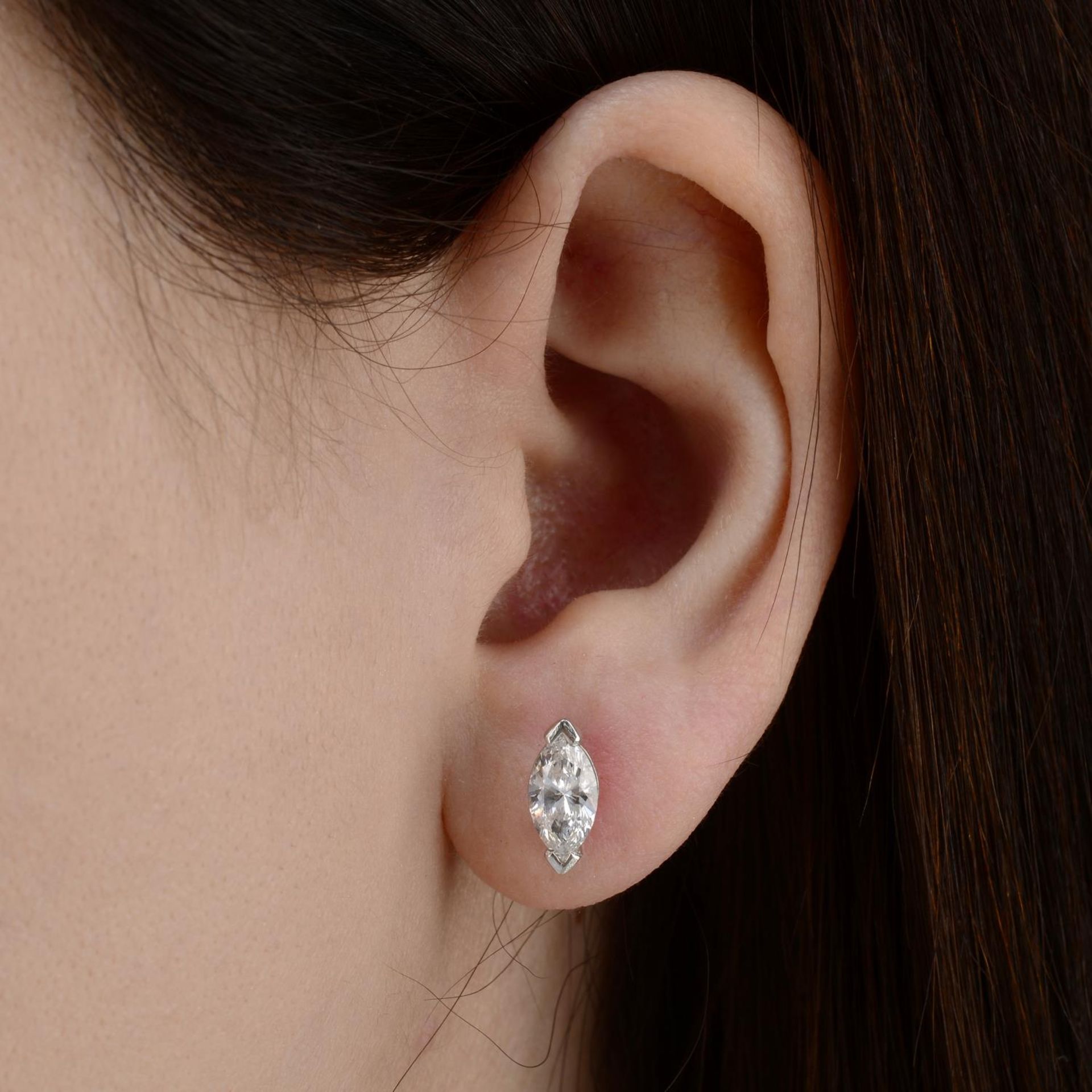 A pair of marquise-shape diamond stud earrings.