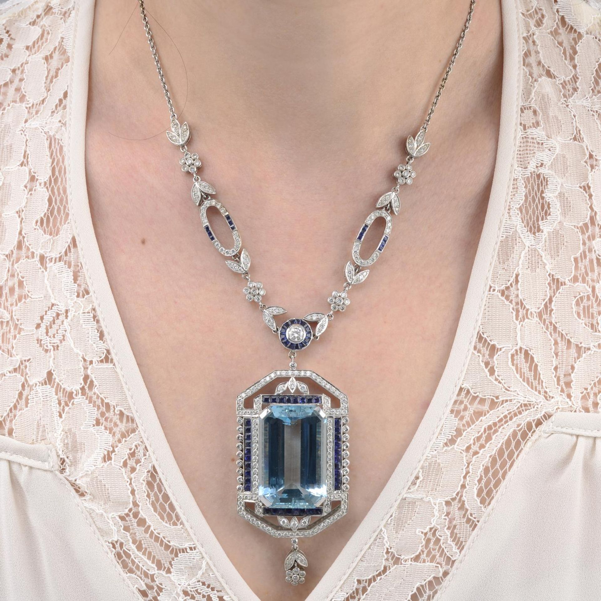 An aquamarine, sapphire and brilliant-cut diamond necklace.Aquamarine calculated weight 63.6cts,