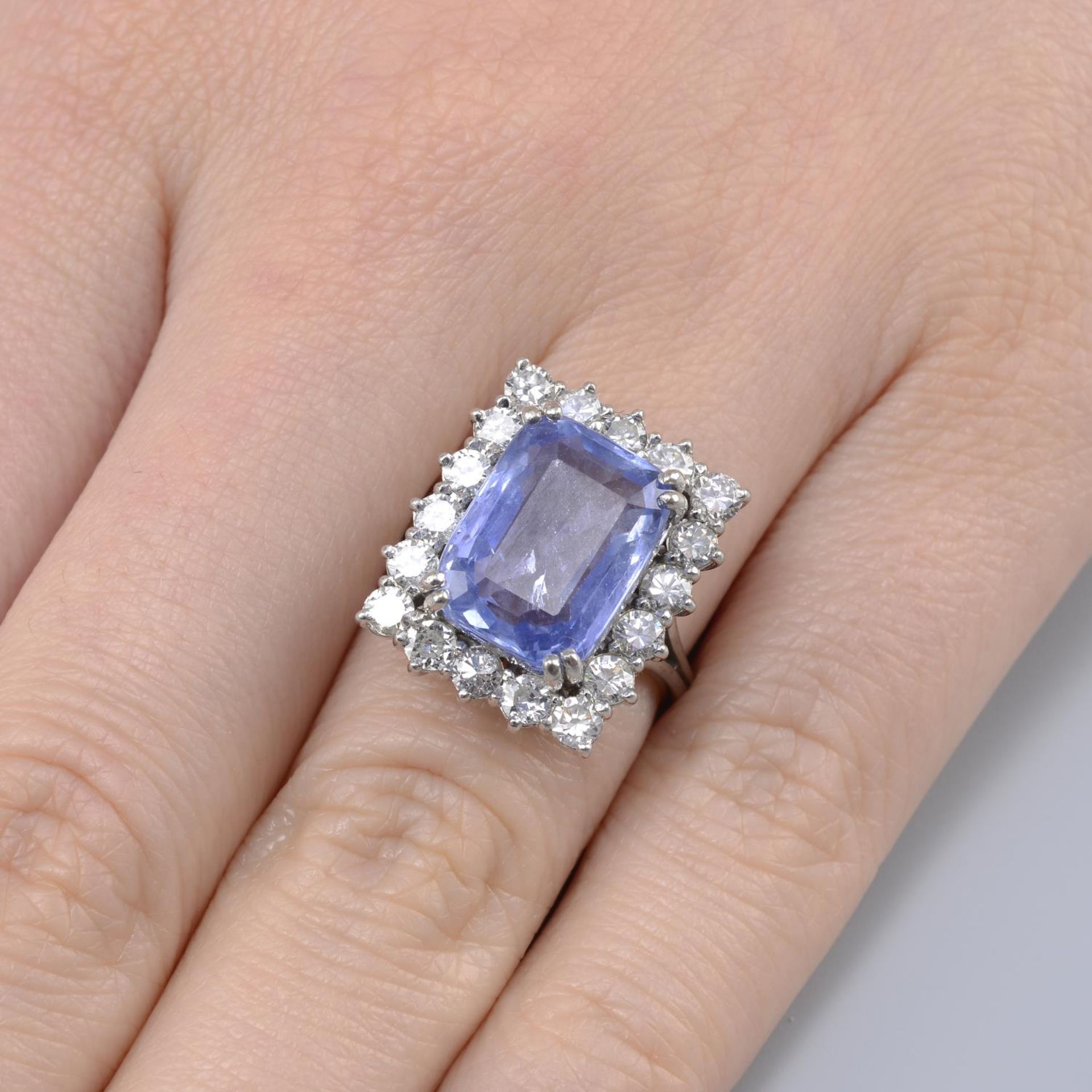 A Sri Lankan sapphire and circular-cut diamond rectangular cluster ring.