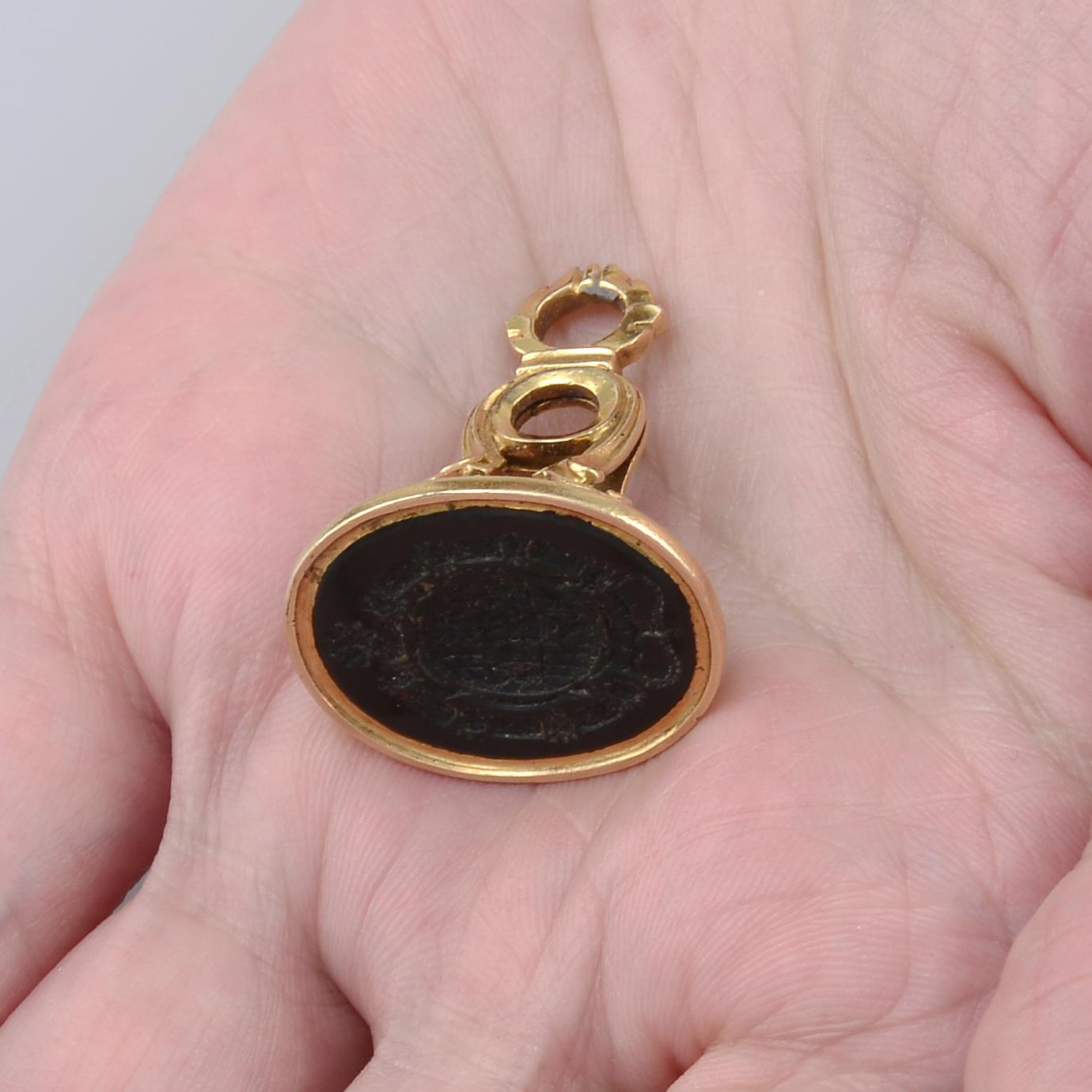 A Georgian 18ct gold carved bloodstone seal.Carved with the Coat of Arms of Frederick Michael,