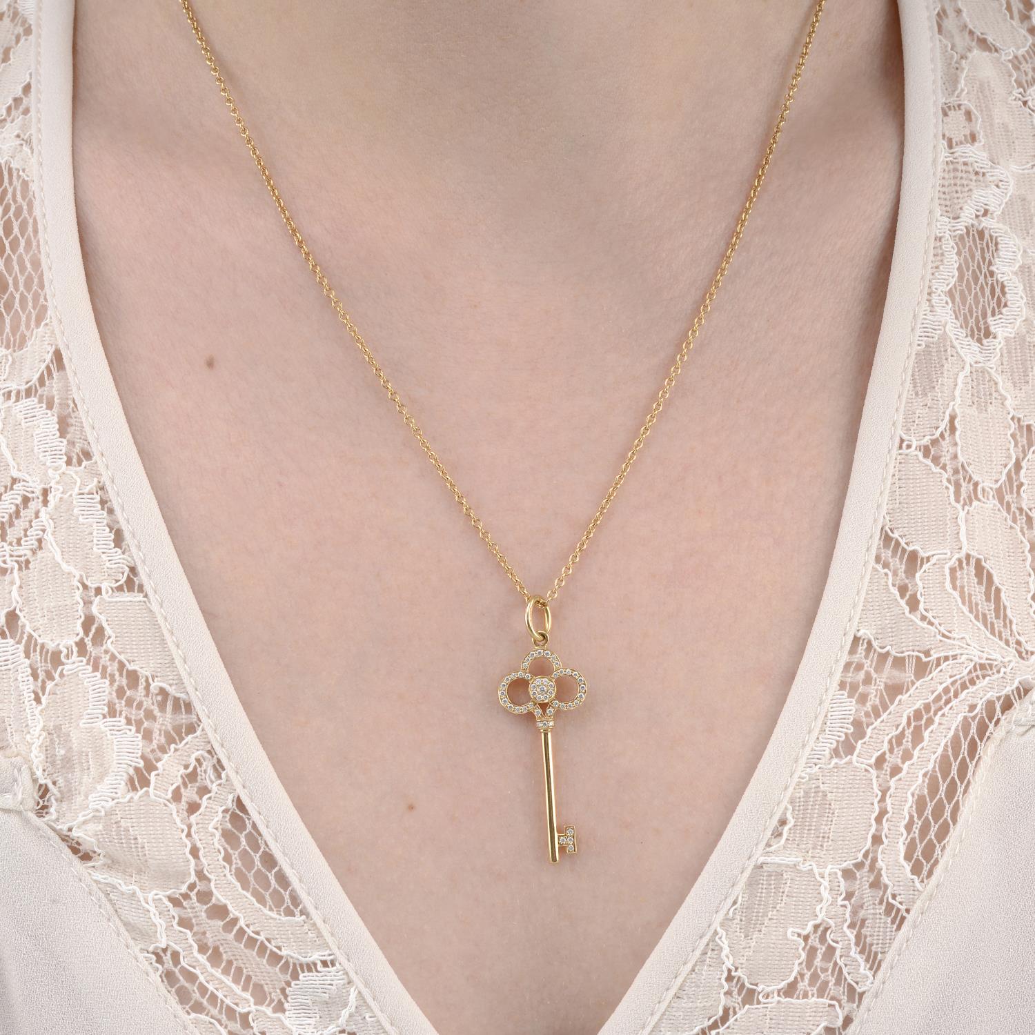 An 18ct gold diamond key pendant, with chain, by Tiffany & Co.