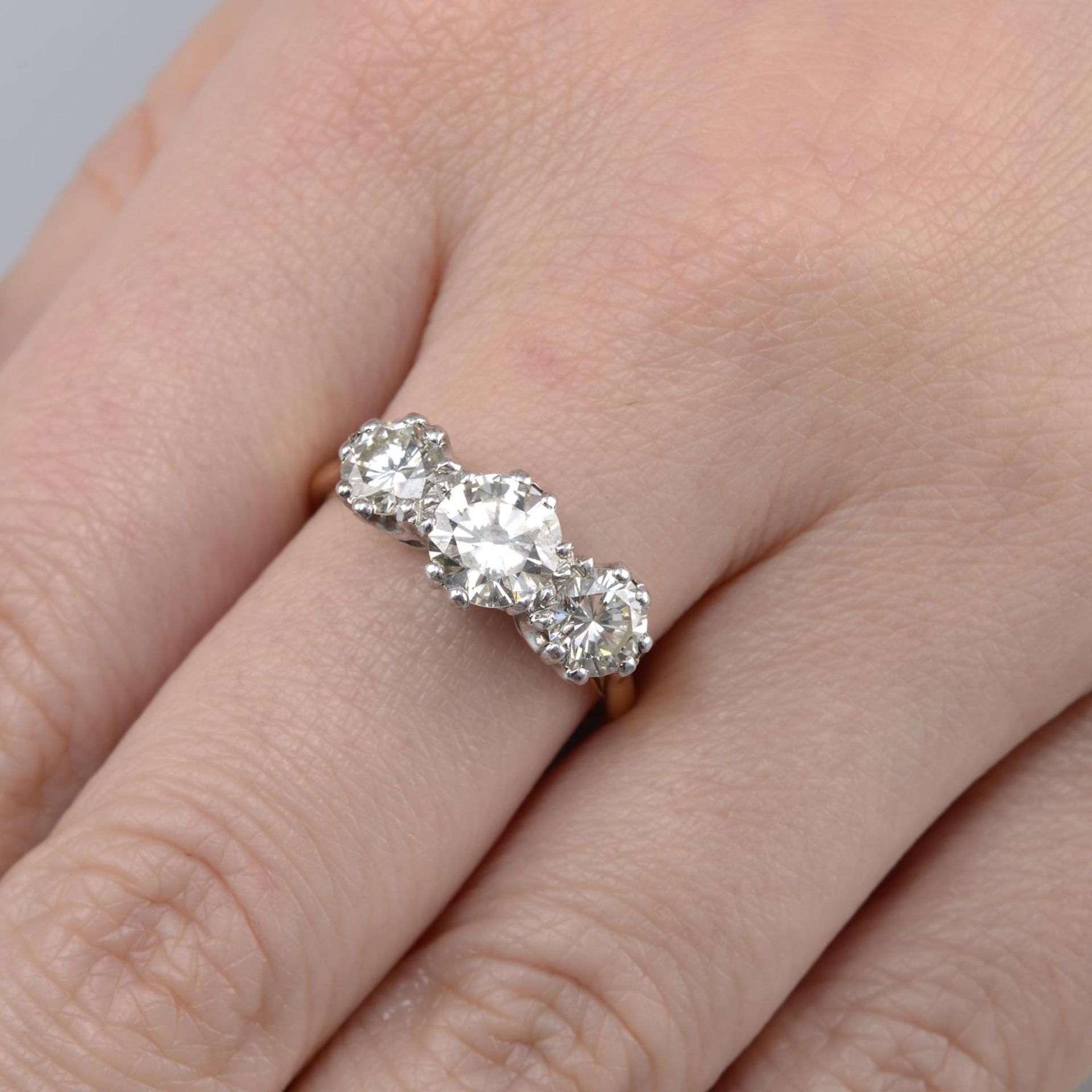 A graduated brilliant-cut diamond three-stone ring.Estimated total diamond weight 1.80cts,
