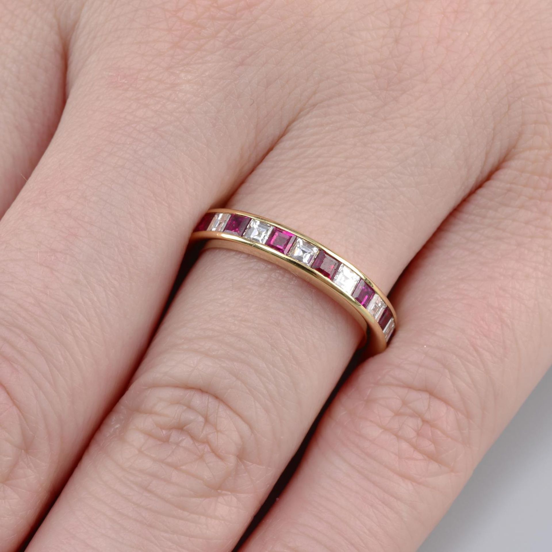 An alternating square-shape diamond and ruby full eternity ring,