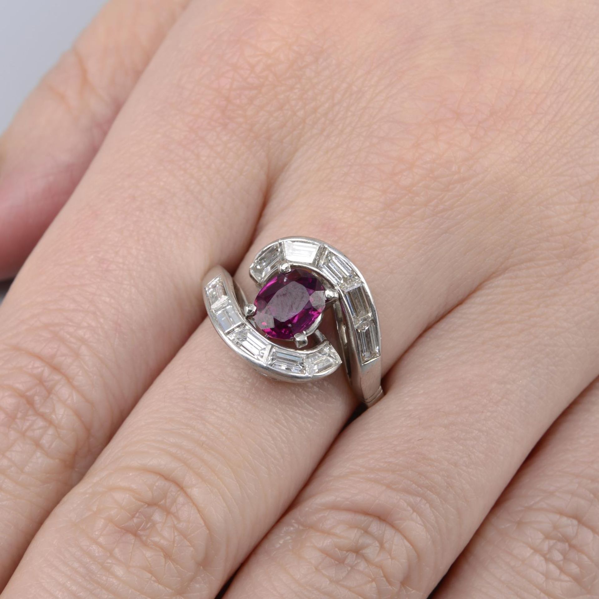 A Thai ruby and baguette-cut diamond asymmetric dress ring.With report number 80249-51,