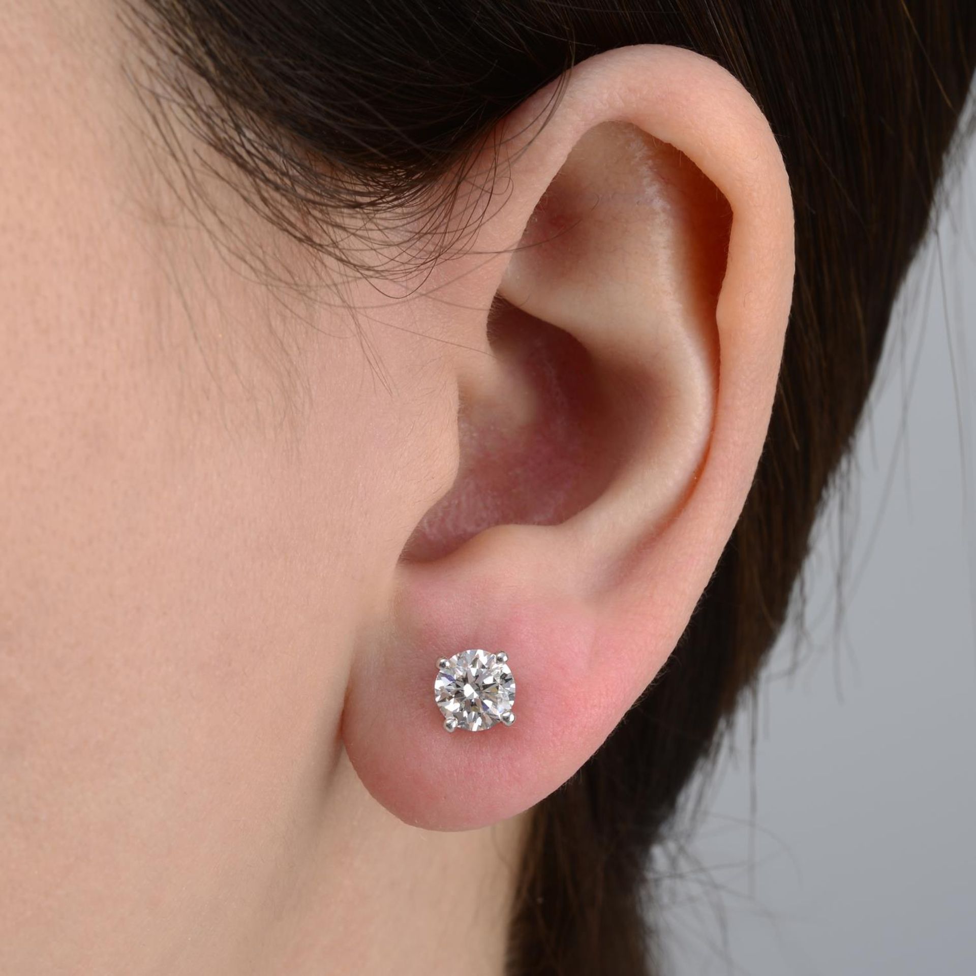 A pair of brilliant-cut diamond stud earrings,