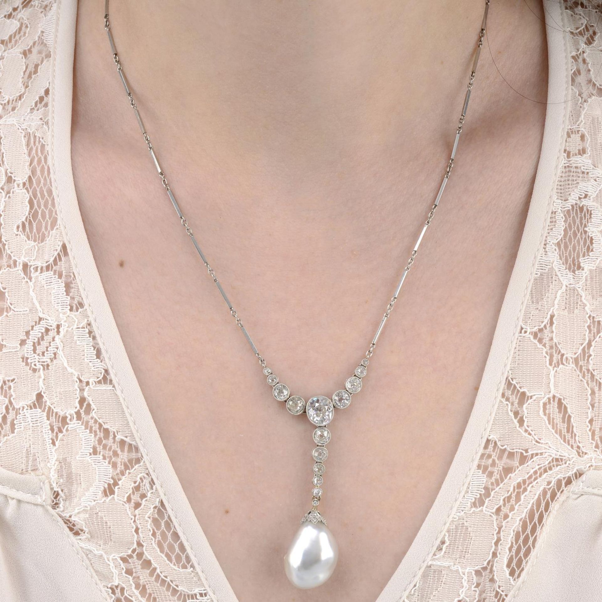 An early 20th century platinum natural saltwater baroque pearl and old-cut diamond necklace.Pearl