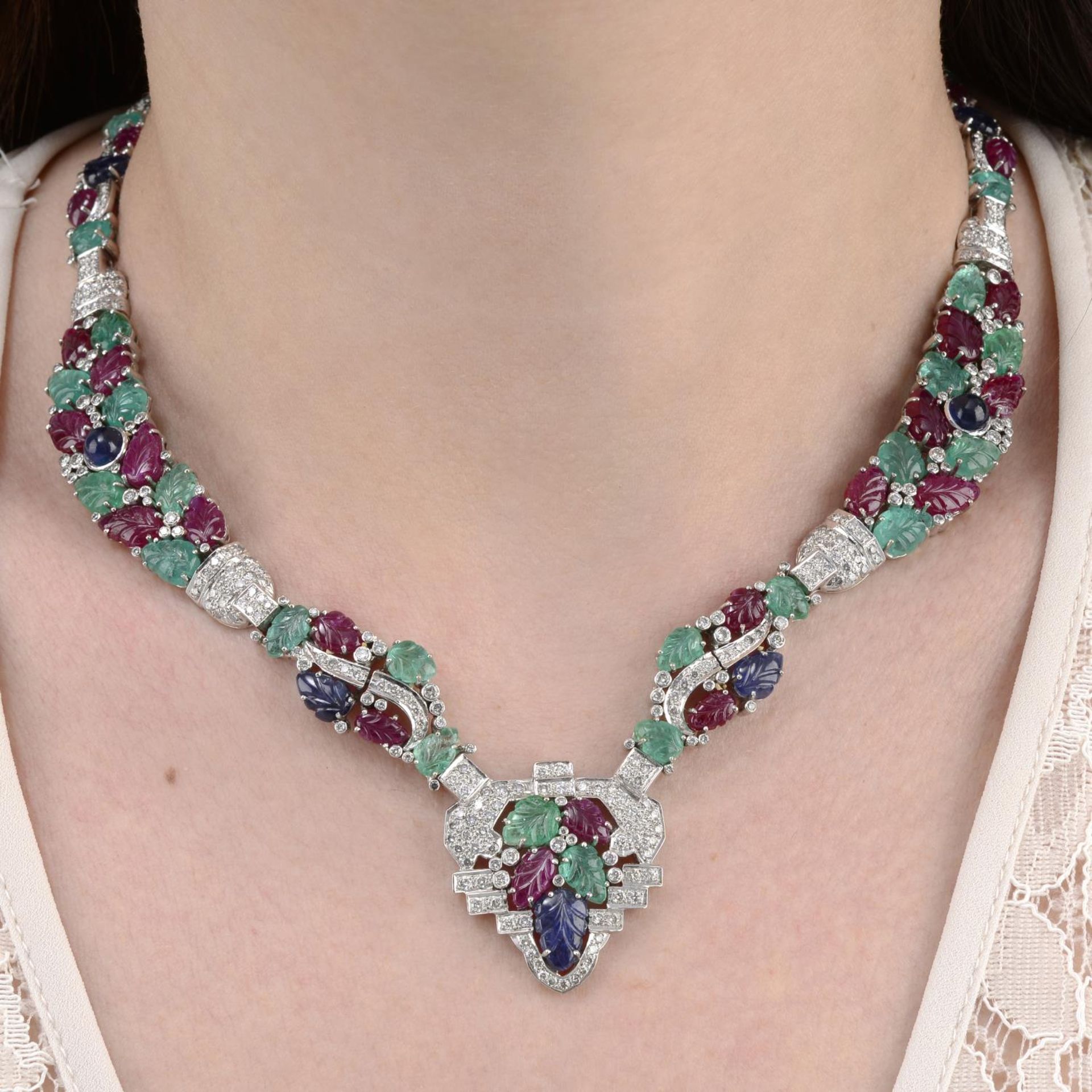 A geometric necklace, set with diamond and carved ruby, emerald and sapphire.
