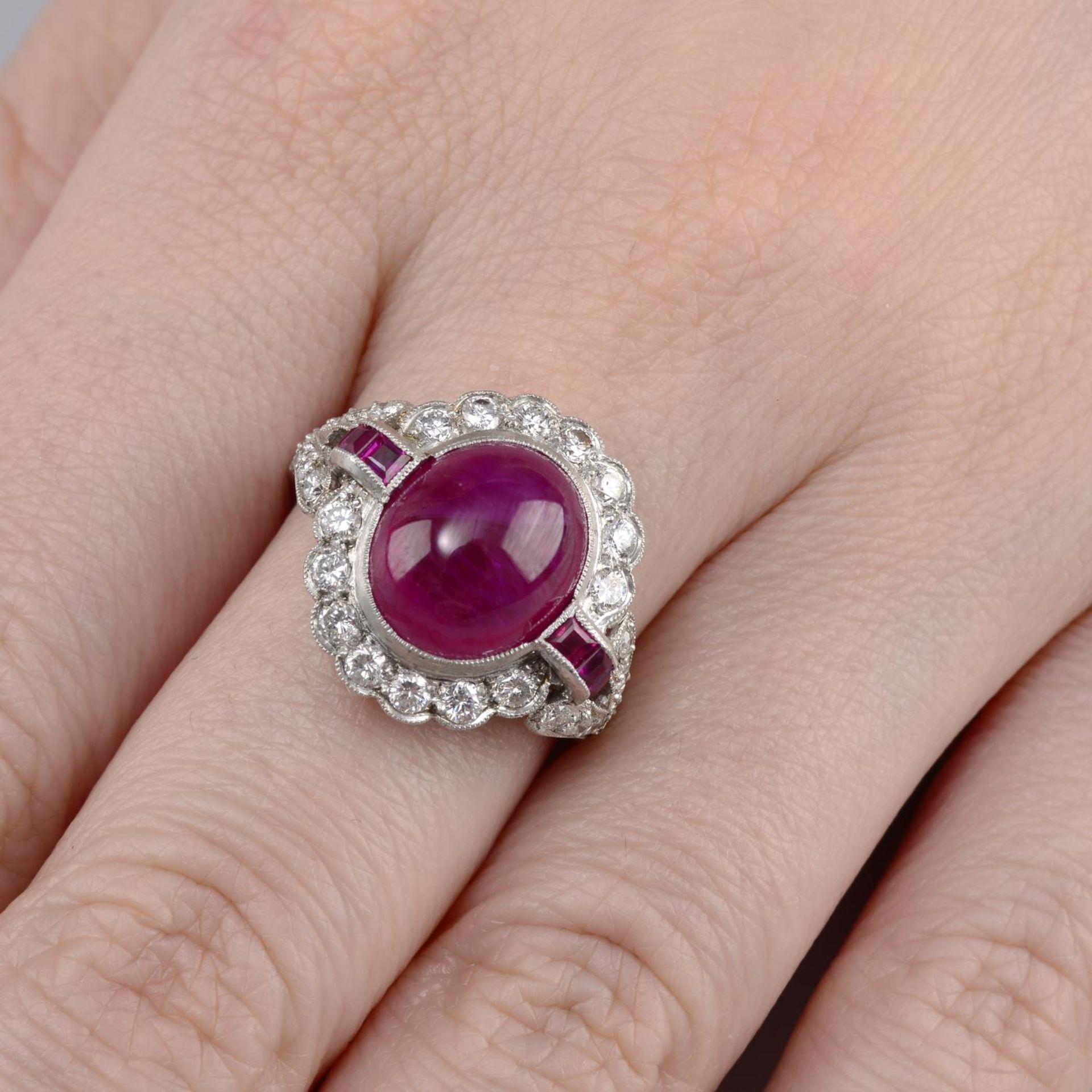 A ruby and brilliant-cut diamond cluster ring.