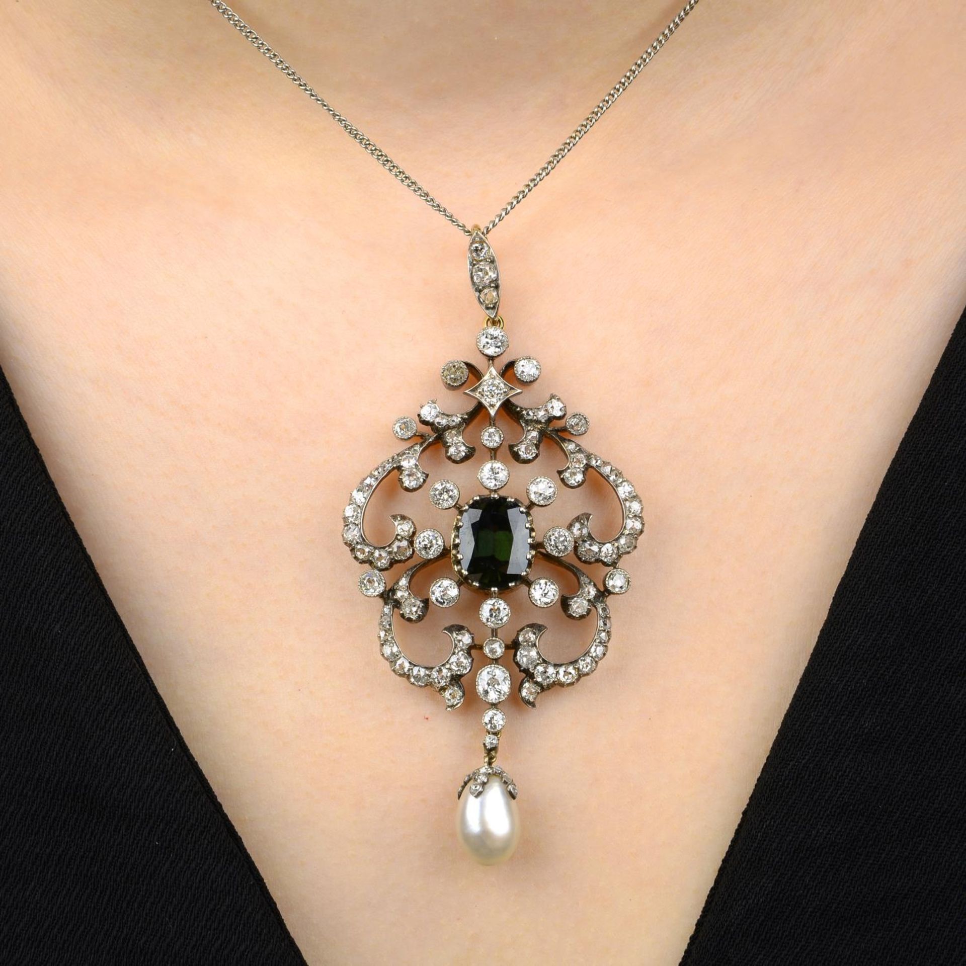 A late Victorian silver and gold green tourmaline, pearl and diamond pendant, with later chain.