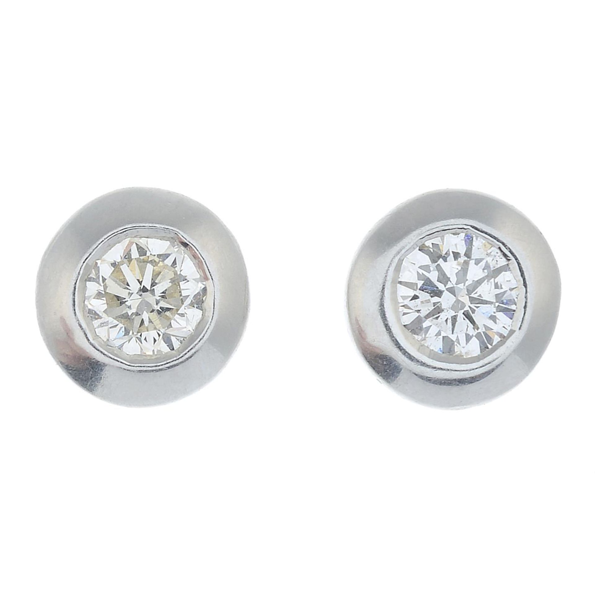 A pair of platinum brilliant-cut diamond stud earrings.Estimated total diamond weight 0.40ct,