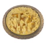 An early 20th century gold, carved ivory brooch, depicting a Chinese village street scene.