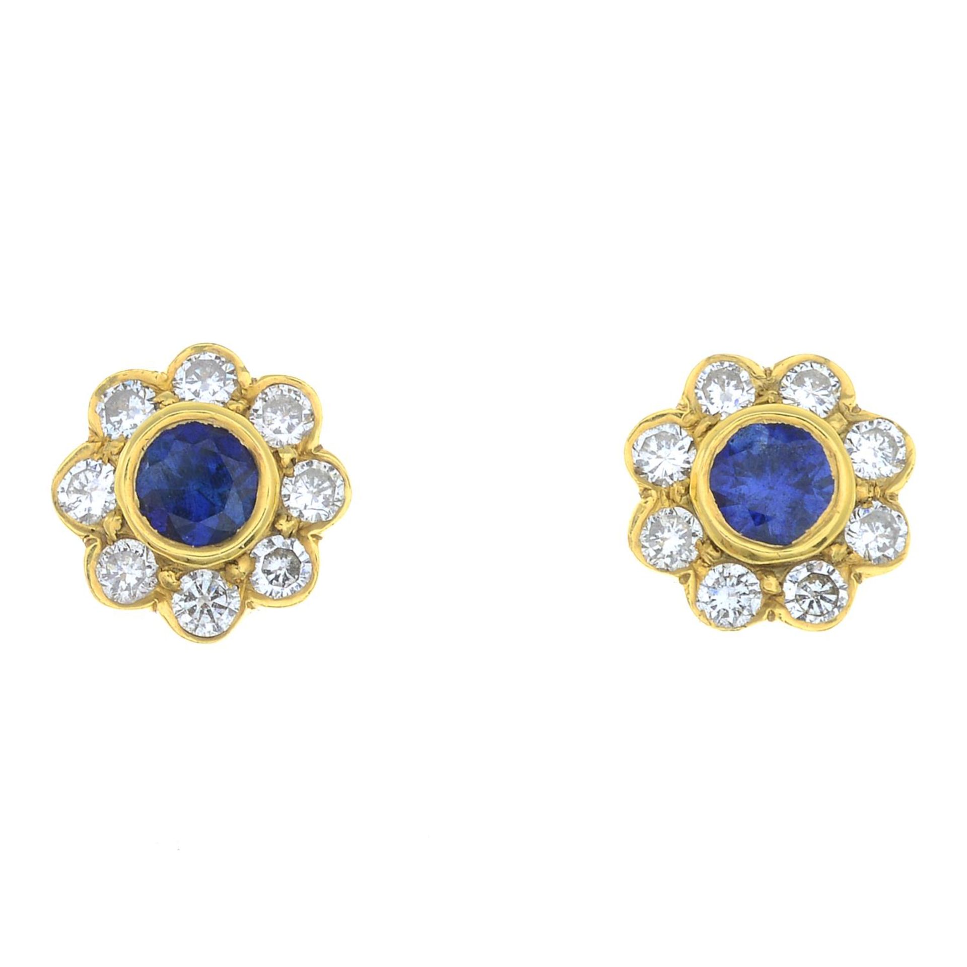 A pair of 18ct gold sapphire and diamond stud earrings.Estimated total diamond weight 0.25ct.