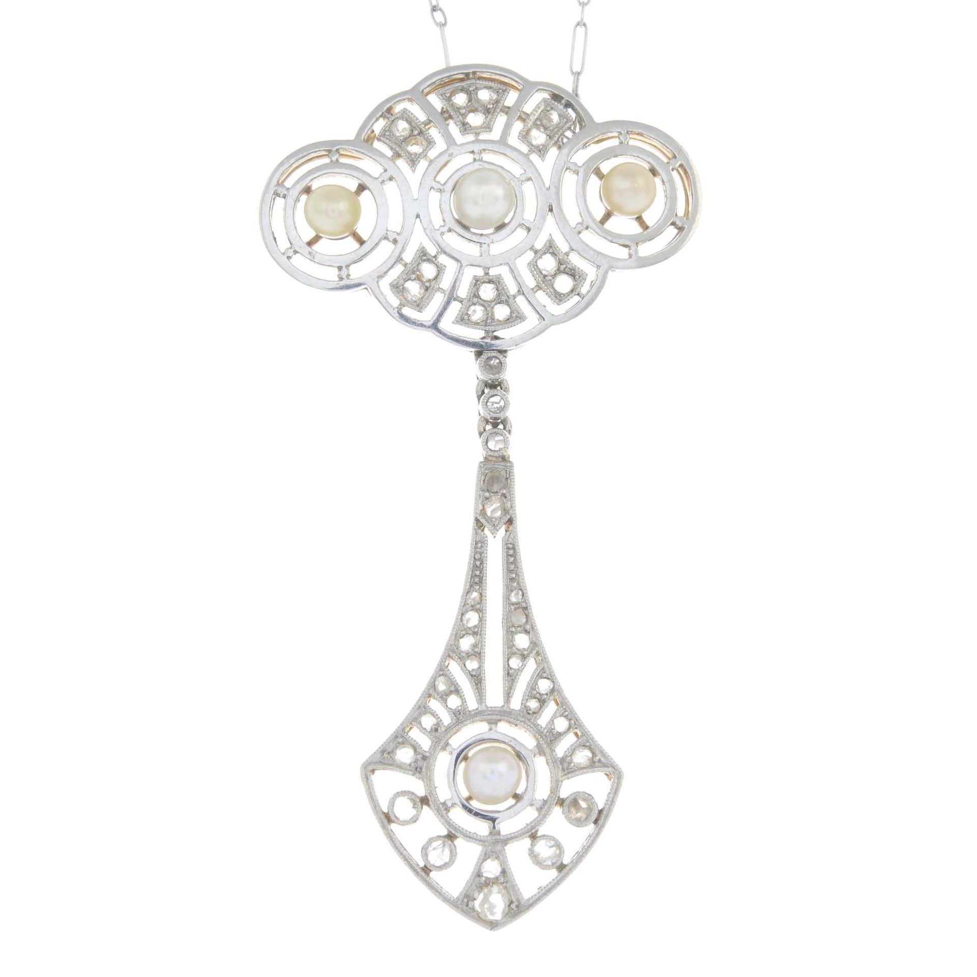 An early 20th century platinum and gold pearl and diamond openwork pendant,