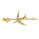 An early 20th century gold split pearl bar brooch, depicting a swallow and a leaf.Length 4.2cms.
