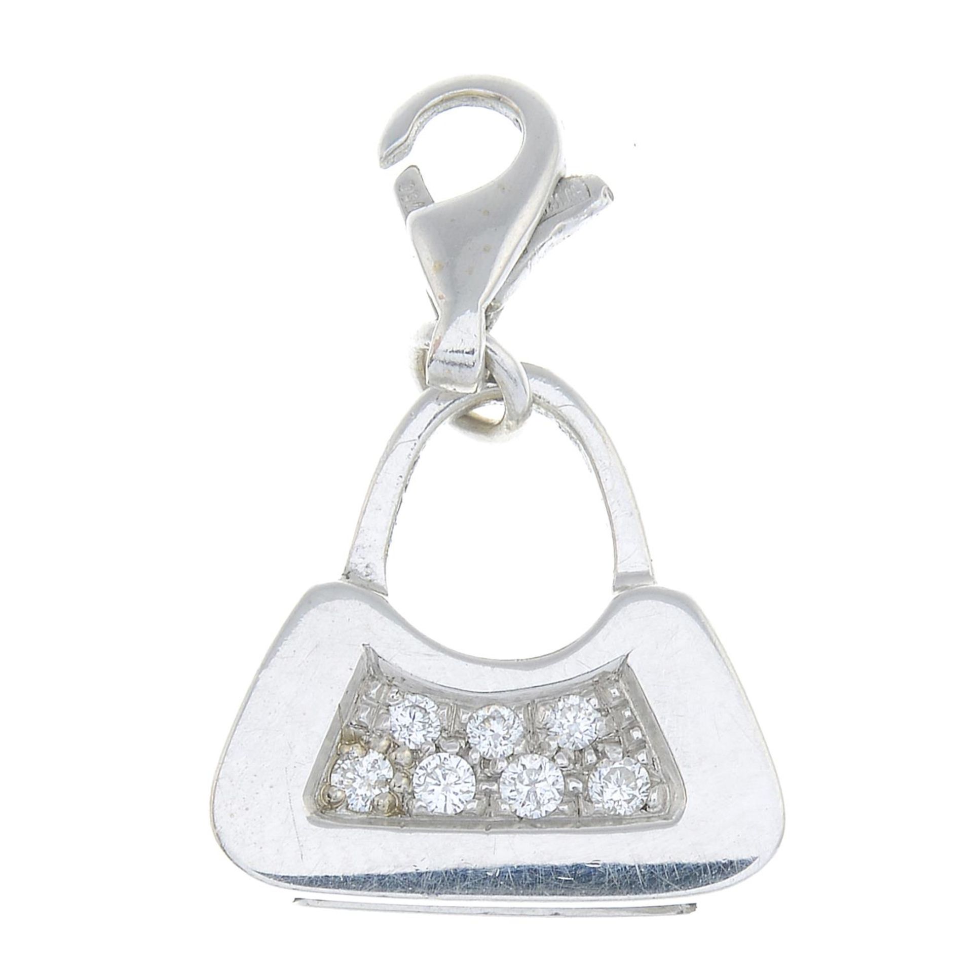 A diamond handbag charm.Estimated total diamond weight 0.10ct.