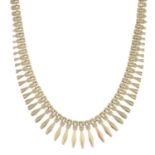A 9ct gold brick-link necklace, suspending a series of graduated fringes.Hallmarks for 9ct gold.