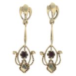 A pair of drop earrings, each with garnet highlight.Stamped 14K.