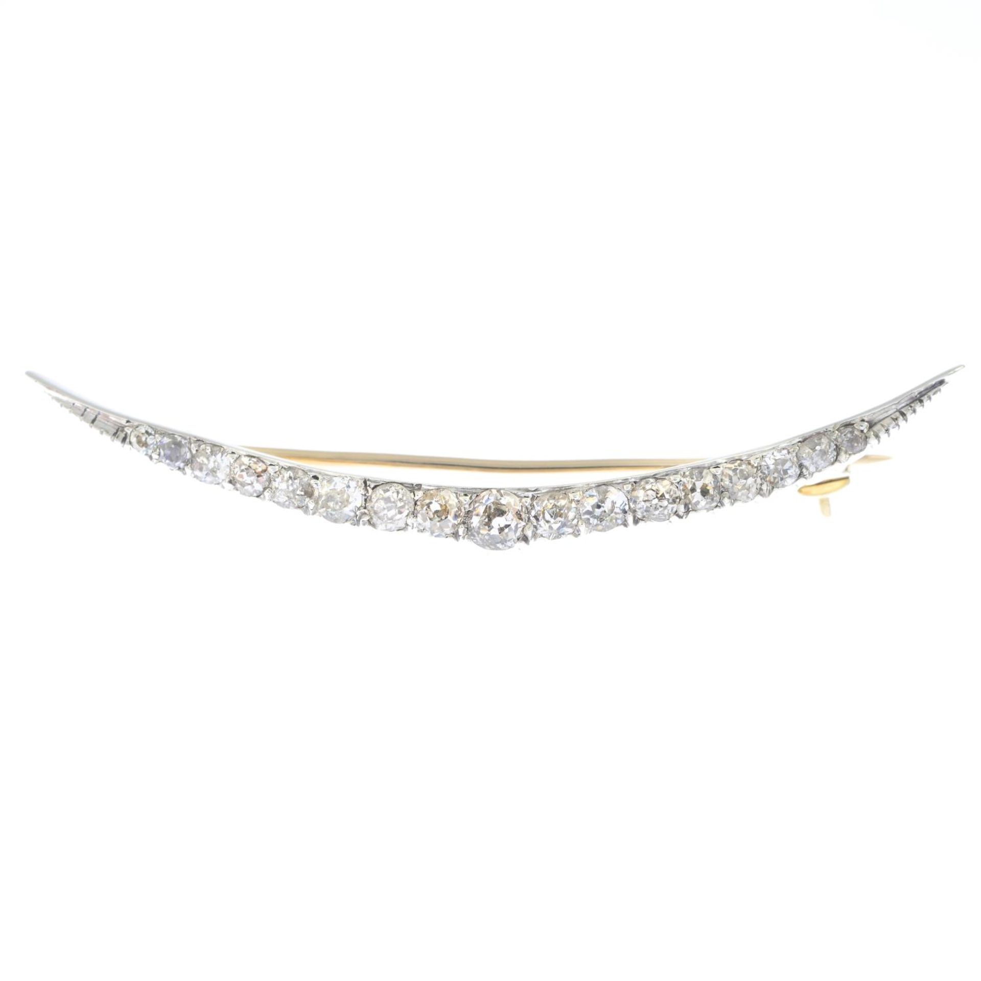 A diamond crescent brooch.Estimated total diamond weight 0.70ct.