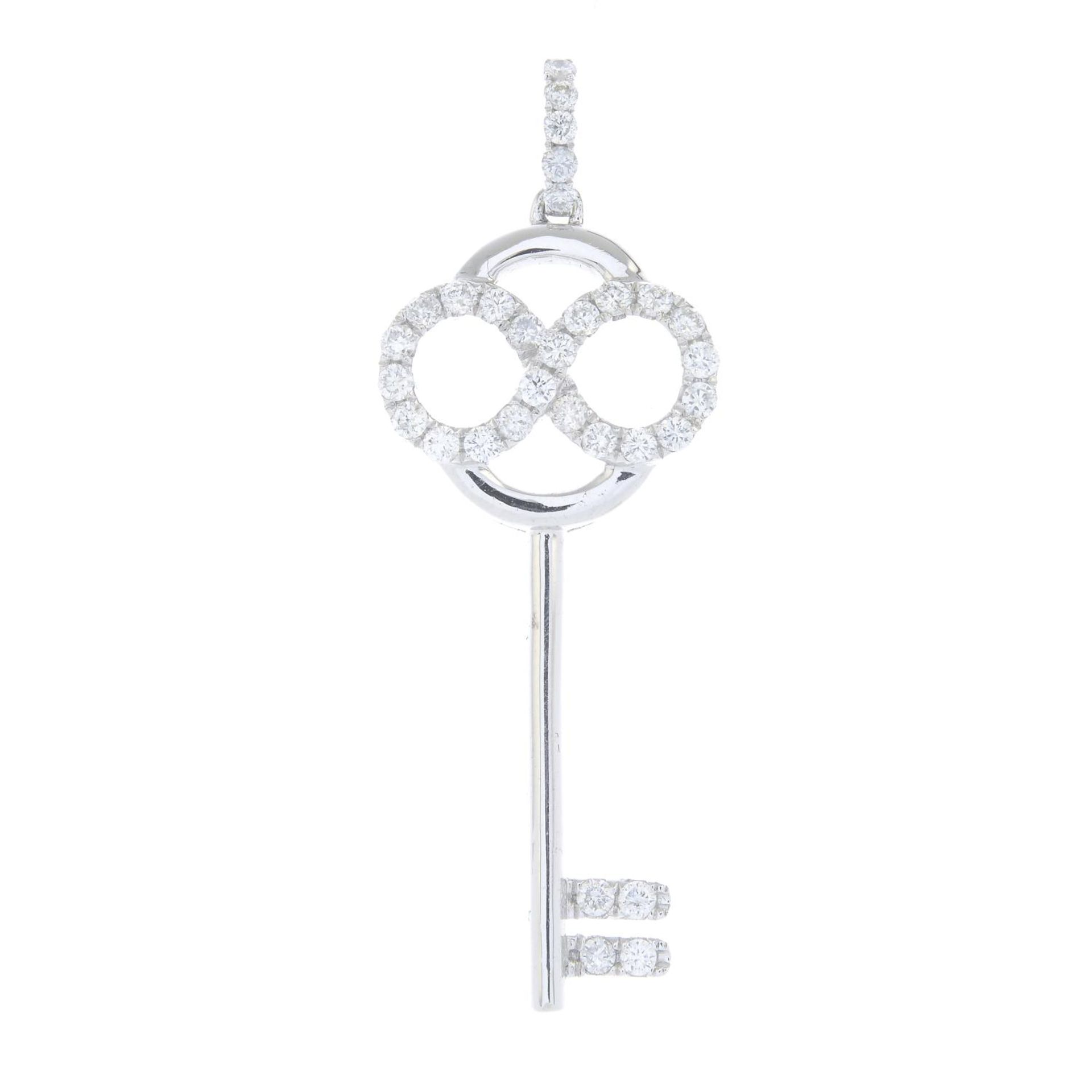 A brilliant-cut diamond key pendant.Estimated total diamond weight 0.65ct, H-I colour, SI clarity.