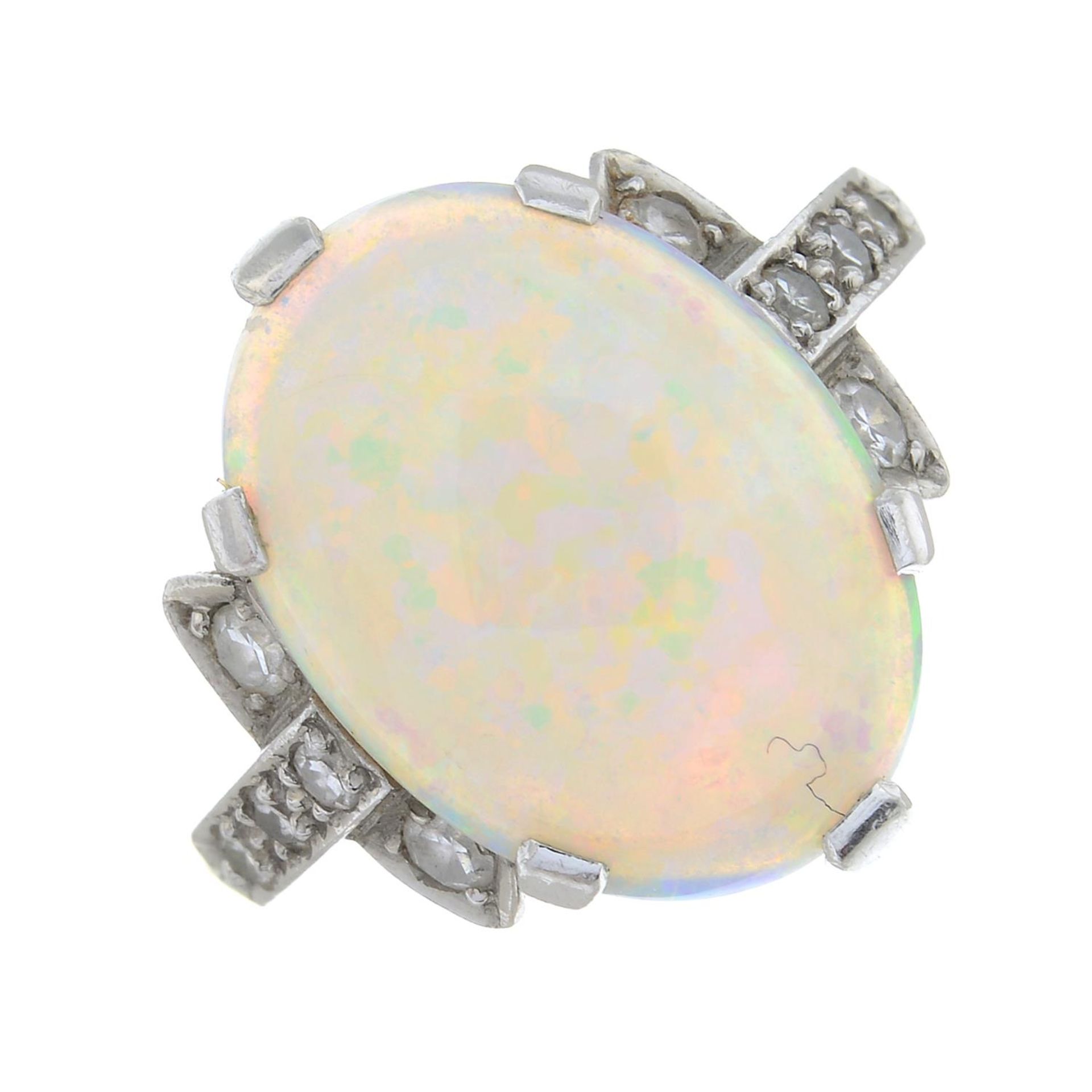 An opal cabochon and circular-cut diamond dress ring.Estimated total diamond weight 0.15ct,