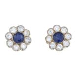 A pair of sapphire and brilliant-cut diamond cluster earrings.Total sapphire calculated weight