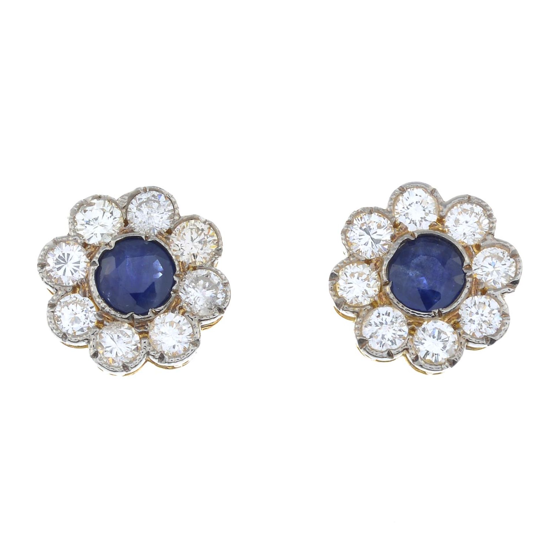 A pair of sapphire and brilliant-cut diamond cluster earrings.Total sapphire calculated weight
