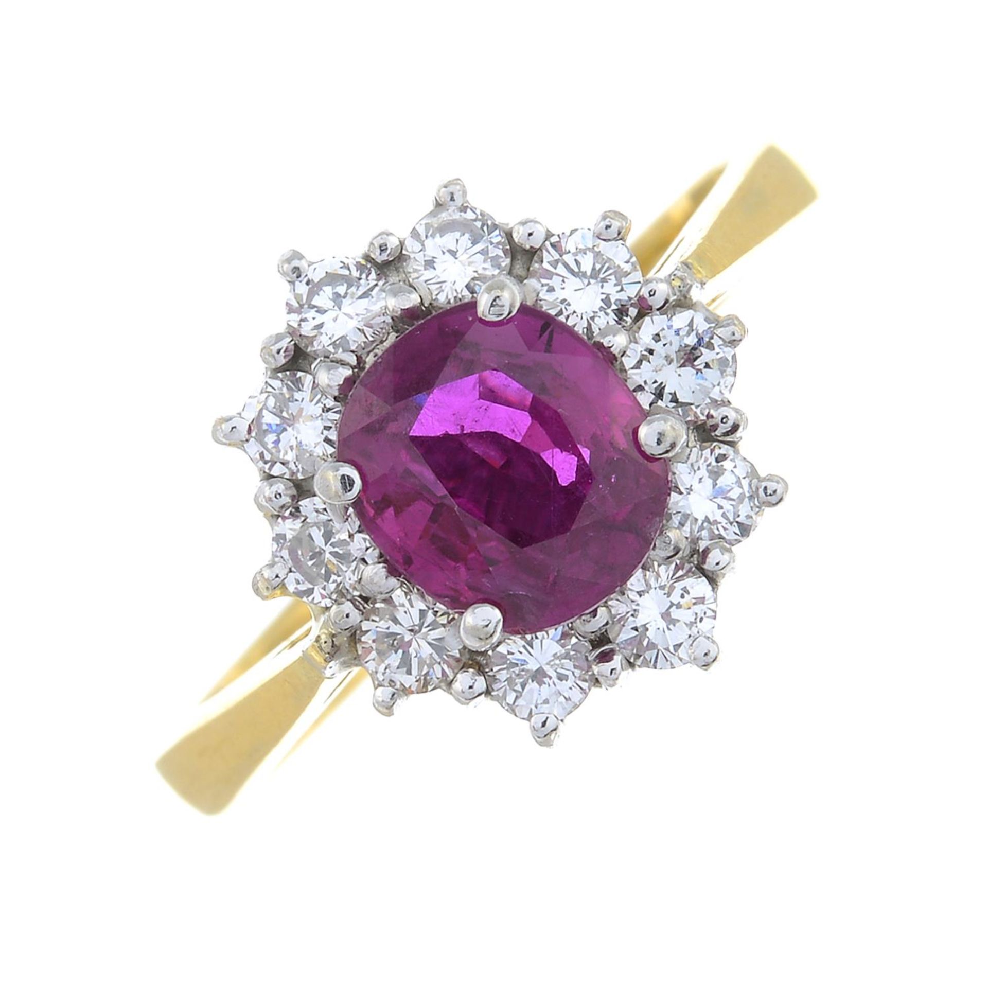 An 18ct gold ruby and brilliant-cut diamond cluster ring.Ruby calculated weight 0.77cts,