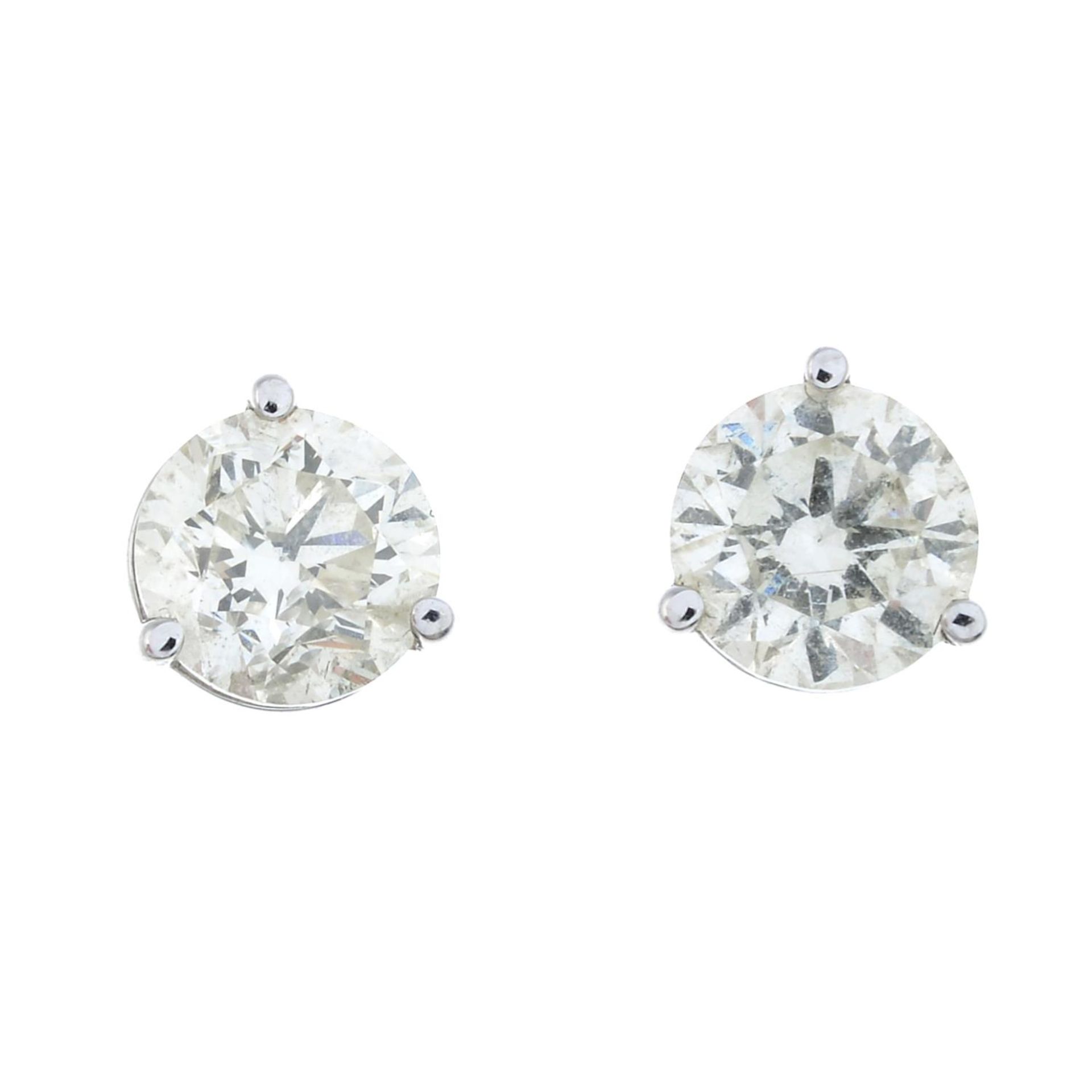 A pair of brilliant-cut diamond single-stone stud earrings.Estimated total diamond weight 1ct,