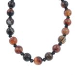 A banded agate single-strand necklace.Length 40cms.