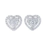 A pair of diamond heart earrings.Total diamond weight 0.22ct, stamped to mount.