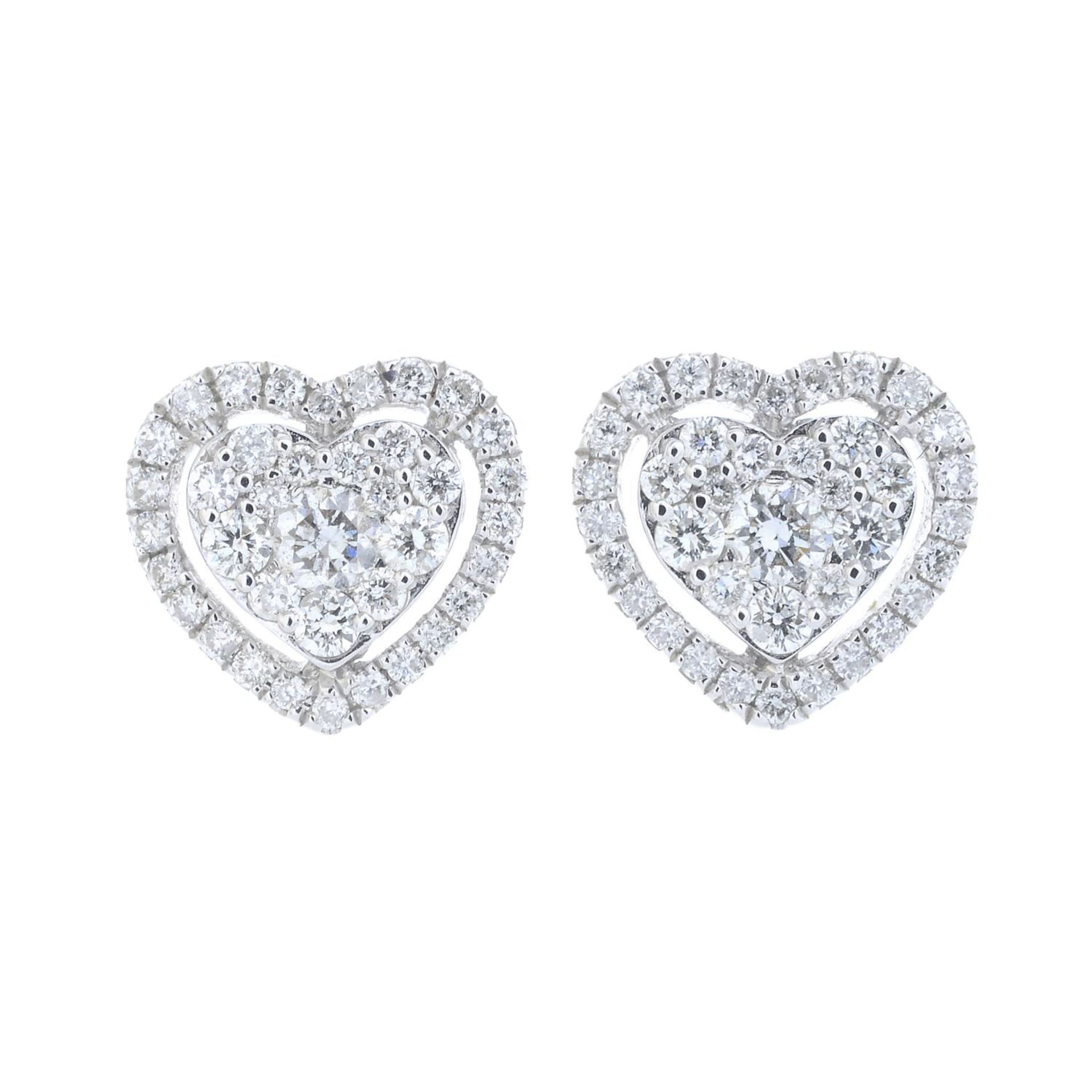 A pair of diamond heart earrings.Total diamond weight 0.22ct, stamped to mount.