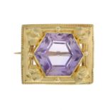 An amethyst brooch, with foliate accent surrond.Length 2.3cms.