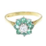 An 18ct gold emerald and diamond cluster ring.One green gem replacement.Estimated diamond weight