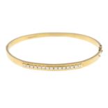 A 9ct gold brilliant-cut diamond hinged bangle.Estimated total diamond weight 0.60ct.Hallmarks for