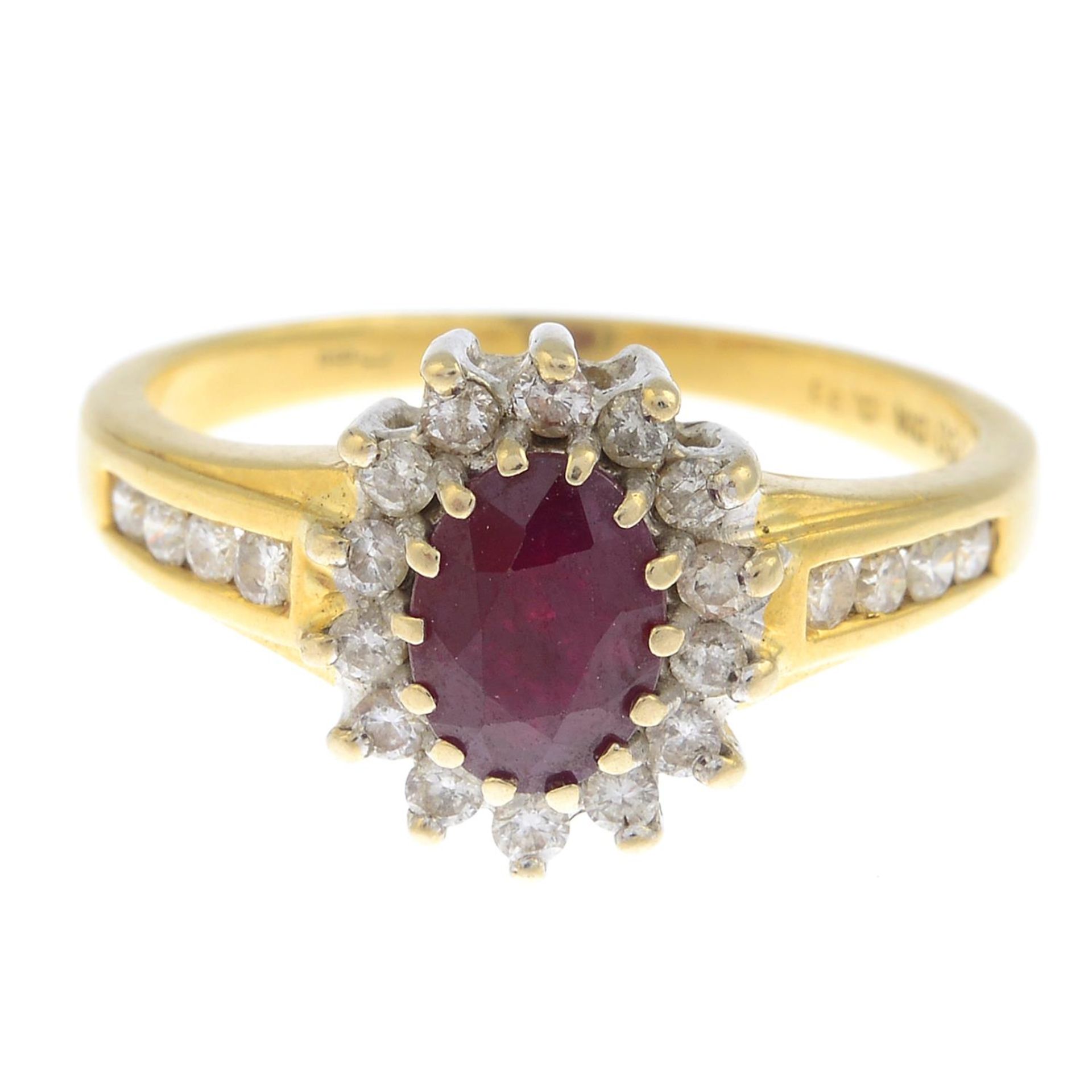 An 18ct gold ruby and diamond cluster ring.Total diamond weight 0.33ct, stamped to band.