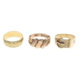 Four 9ct gold rings, to include a keeper ring, a buckle ring, and two further rings.