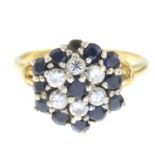 A sapphire and brilliant-cut diamond cluster ring.One sapphire deficient.Estimated total diamond